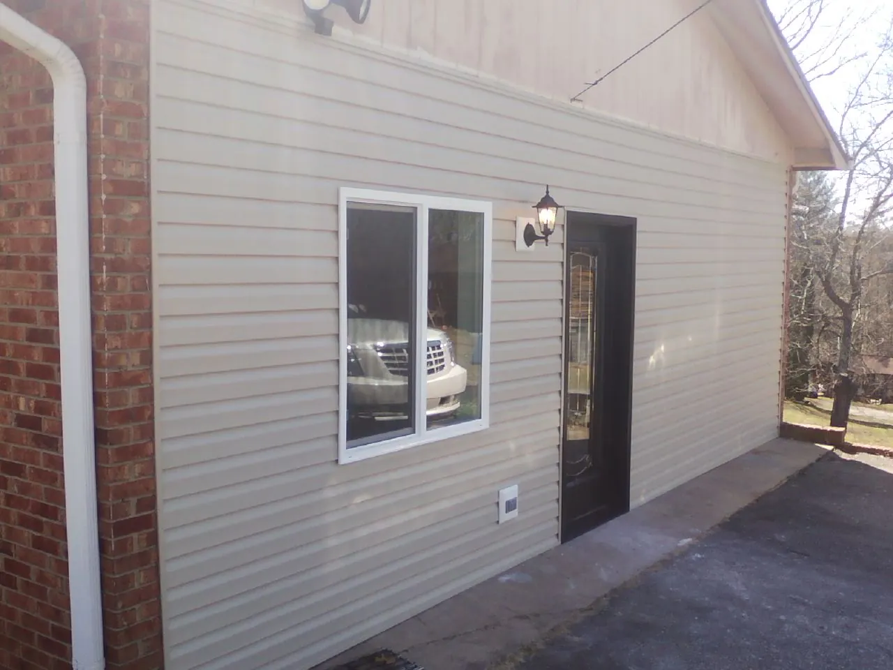 New vinyl siding and entry door on a room addition in Wildomar