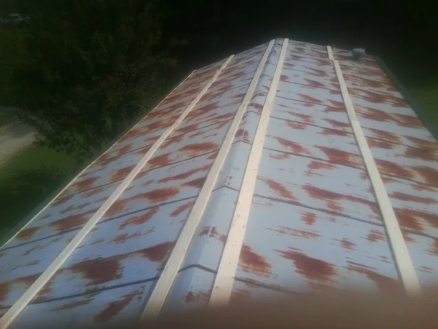 Rusted metal roof panels with new wood purlins before replacement — Storm Damage Roof Repair in Wildomar by Roofing Brothers